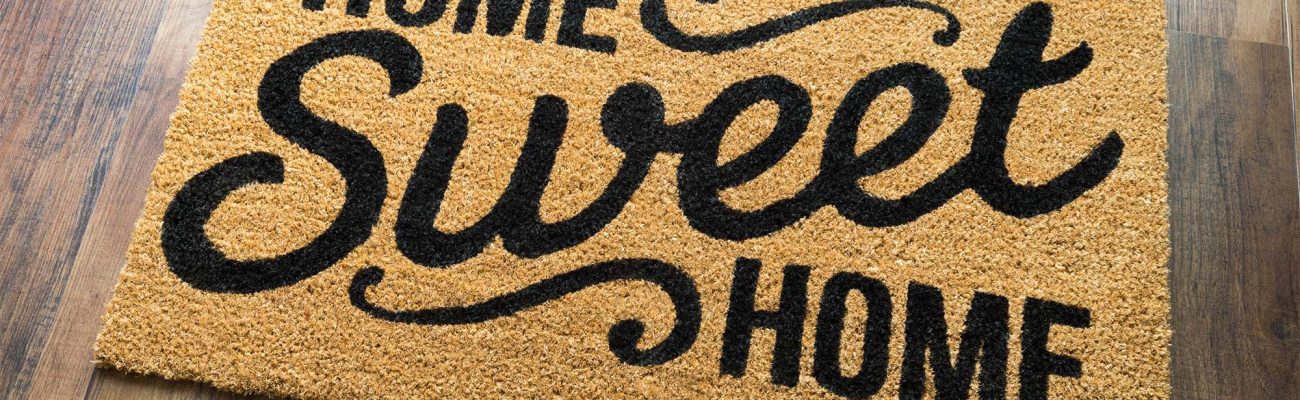Home Sweet Home Welcome Mat On Wood Floor. Home Sweet Home Welcome Mat On Wood Floor.